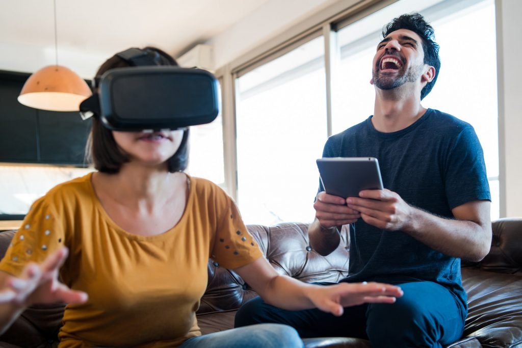 Couple playing video games with VR glasses.